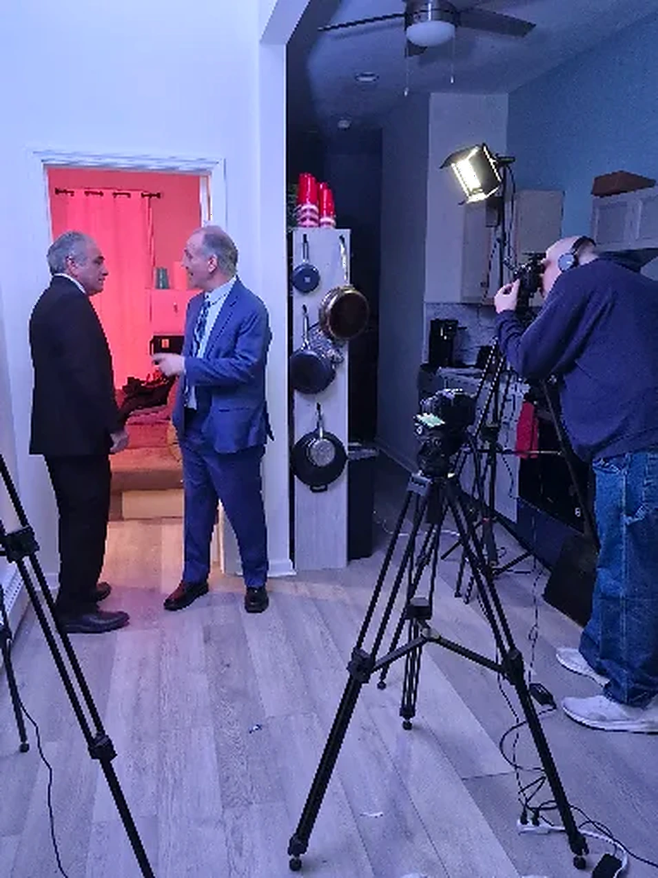 Crew filming a dialogue scene on a lit interior set